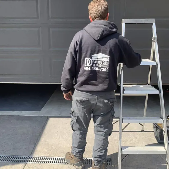 DD Garage Door Repair technician working on a garage door