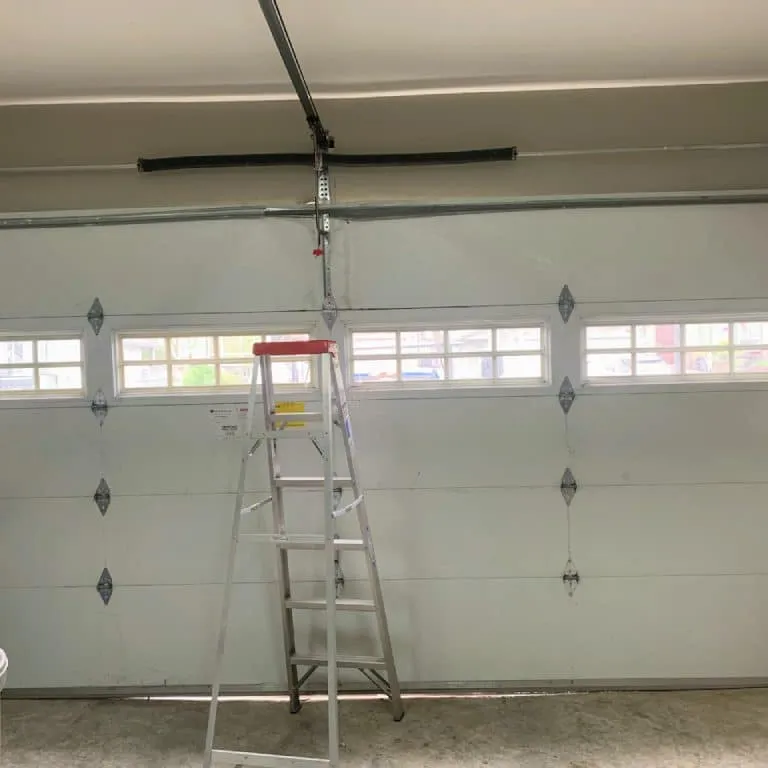 Technician servicing garage door system